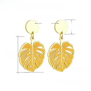 Detailed macro of 18K gold plated leaf earrings with polished monstera leaf pendants