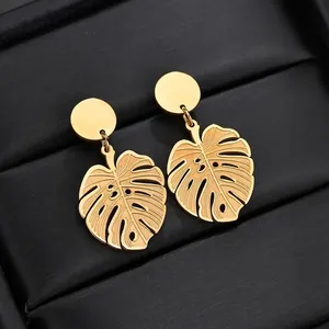 Vintage gold monstera leaf earrings in titanium steel with a luxury metallic finish