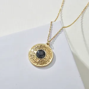 Vintage gold necklace with round turquoise relief pendant on white minimalist display