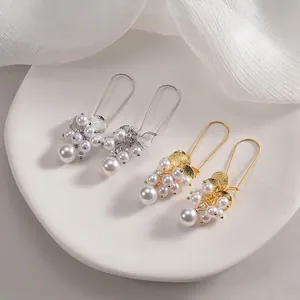 Elegant pearl cluster grape earrings with brushed metal discs in gold and silver finishes