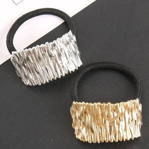 Close-up of alloy hair ties with irregular metal texture in gold and silver finish