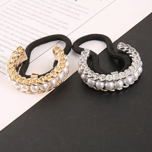 Detailed macro of elastic hair ties with gold and silver pearl-encrusted metal buckles