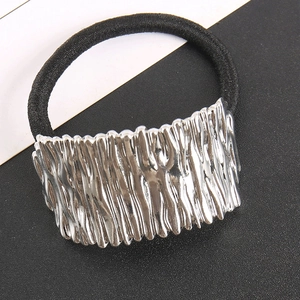 Detail of silver alloy hair tie showing the vertical fluid metal texture and black elastic