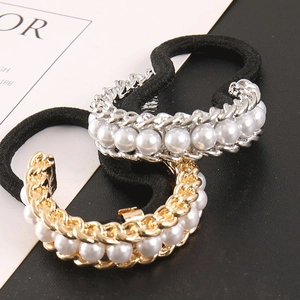 Detail of high-elastic black hair bands with gold and silver U-shaped pearl metal base