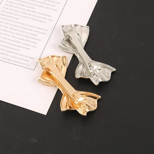Elegant gold and silver metal bow hair clips set with spring clamp backing detail