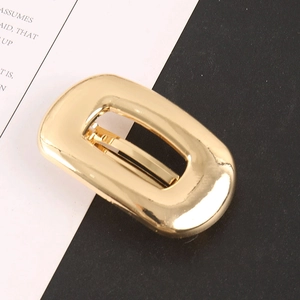 Minimalist golden hollow rectangular hair clip with polished metallic finish and modern style