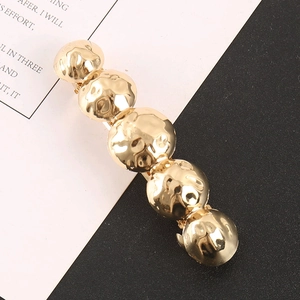 Golden hammer-textured ball hair clip featuring five spherical alloy design elements