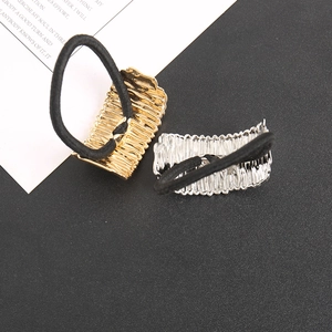 Detail of gold and silver ponytail holders with irregular ripple texture on metal plates