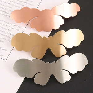 Detail of elegant butterfly hair clips in gold, silver, and rose gold brushed alloy