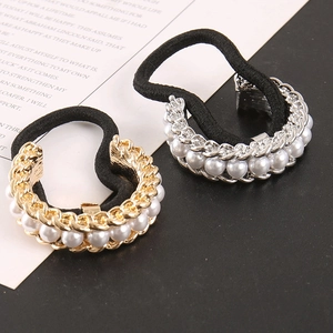 Close-up of pearl hair scrunchies with gold and silver alloy buckles and tiny rhinestones