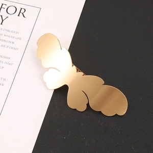 Detailed close-up of matte gold alloy butterfly hair clip with minimalist metal clamp design