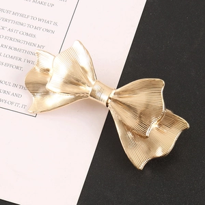 Elegant gold metal bow hair clip with textured double-layer design for women hair styling
