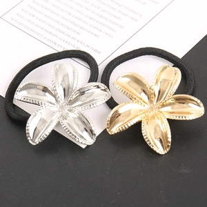Detailed macro view of gold and silver metallic flower hair ties with high elasticity