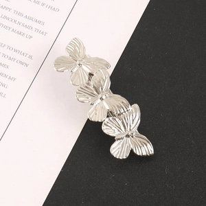 Detailed view of silver butterfly hair clip with intricate wing textures on metallic finish