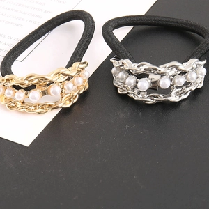 Close-up of pearl chain hair ties with gold and silver links and black elastic bands