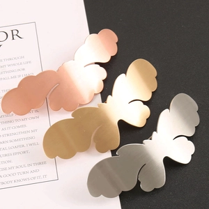 Detailed macro view of butterfly metal clips in gold, silver, and rose gold finishes