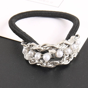 Detail of black elastic hair tie with silver chain links and white faux pearl accents