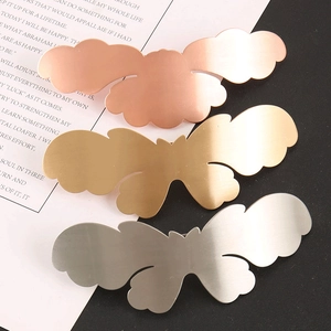 Detailed close-up showing butterfly metal hair clips in rose gold, gold, and silver finishes