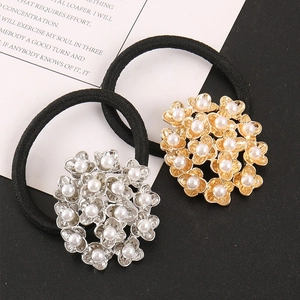 Détail de chouchous élastiques avec pendentifs fleurs en perles dorées et argentées
