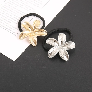 Close-up of golden and silver floral hair ties with high-elastic black cord and metallic finish