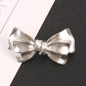 Chic silver bow metal hair claw clip with pleated texture for elegant women styling