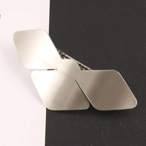 Geometric bird wing alloy hair clip in matte silver finish with duckbill clamp