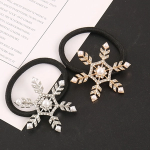 Detail of silver and gold snowflake hair ties with rhinestones and faux pearls