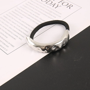 Minimalist metal textured hair tie with silver hammered pattern on black elastic band