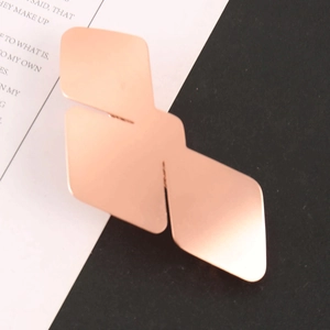 Detailed macro shot of rose gold geometric bird hair clip with matte metallic finish