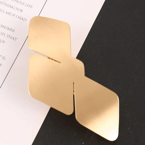 Minimalist matte gold geometric bird-shaped metal hair clip with a modern triple-layered design