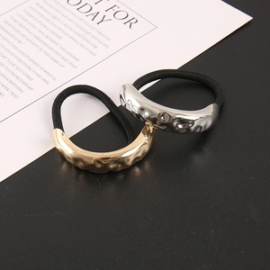 Minimalist metallic elastic hair ties with irregular gold and silver textured geometry