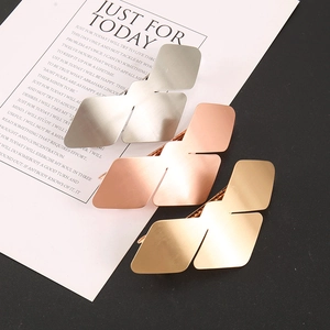 Detailed view of matte brushed metal bird-shaped hair clips in gold silver and rose gold