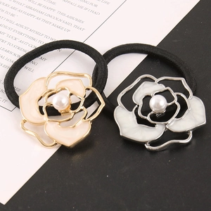 Elegant set of two camellia flower hair ties in gold and silver with imitation pearls