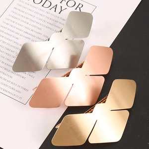 Detailed view of silver, rose gold and gold geometric bird-shaped alloy hair clips