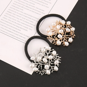 Detail view of gold and silver alloy hair ties with faux pearls and rhinestones
