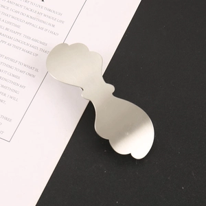 Detail of silver alloy bow hair clip featuring a brushed matte finish and metal texture