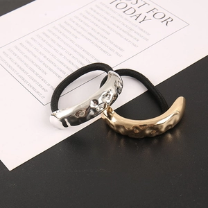 Detail of metallic hair ties featuring irregular hammered texture in gold and silver