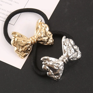 Detail of hip-hop punk hair ties with metallic hammered gold and silver bows