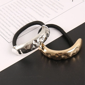 Detail of metallic hammer pattern hair ties in shiny gold and silver finishes