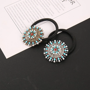 Détail macro d'élastiques bohèmes en turquoise avec métal vintage et gemmes rouges