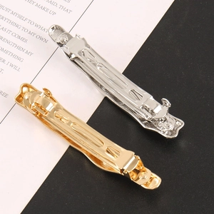 Close-up of gold and silver minimalist metal spring hair clips with dual-row teeth