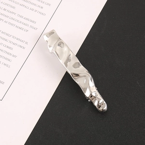 Minimalist silver liquid metal ripple hair clip with a polished geometric wave design