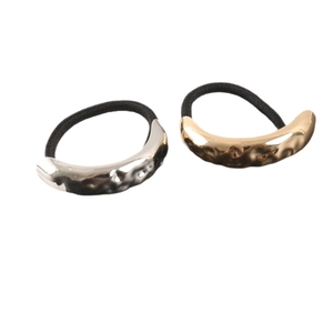 Golden and silver hair ties with irregular lava metal texture on black elastic bands