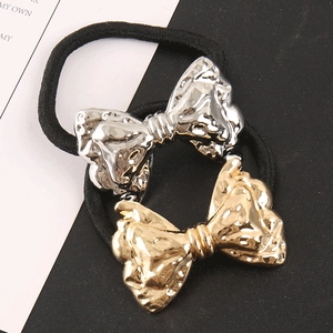 Punk style metallic bow hair ties in gold and silver finish with black elastic bands