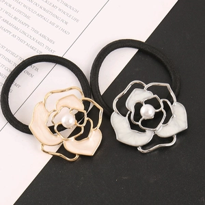 Macro detail of camellia hair rings with champagne and white petals and pearls