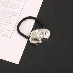 Detailed view of silver lava-textured metal bar on a high-elastic black hair tie