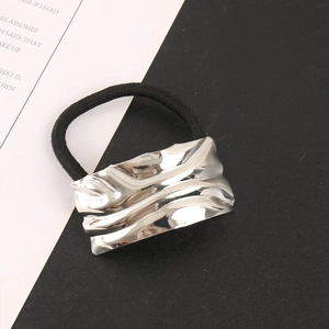 Close-up of square silver alloy ripple hair tie with minimalist black elastic band