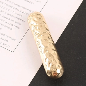 Minimalist alloy hair clip with golden lava texture and shiny metallic finish for women