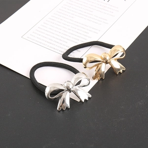 Close-up of gold and silver metallic bow hair ties set on high-elastic black bands