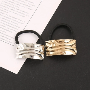 Detail of gold and silver textured alloy rectangle charms on high-elastic hair ties